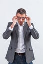 Thinking middle aged businessman adjusting his eyeglasses to read Royalty Free Stock Photo