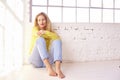 Thinking middle aged woman relaxing on the floor Royalty Free Stock Photo