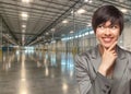 Thinking Mixed Race Businesswoman Standing in Empty Industrial Warehouse Royalty Free Stock Photo