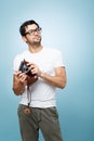 Thinking about the next shot. a young male photographer taking photos against a studio background. Royalty Free Stock Photo