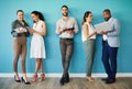 Thinking on our feet. Full length shot of a diverse group of businesspeople standing together in the office and using Royalty Free Stock Photo