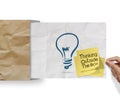 thinking outside the box on sticky note and lightbulb as creative on crumpled envelope paper Royalty Free Stock Photo