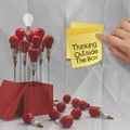 Thinking outside the box on sticky note and pencil lightbilb as Royalty Free Stock Photo