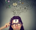 Thinking perplexed woman with question mark looking up Royalty Free Stock Photo