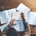 Thinking, planning and brainstorming business man reading and writing notes at a desk from above. Creative male drawing Royalty Free Stock Photo