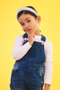 Thinking, portrait and girl child in studio with choice, decision or ask sign on yellow background. Why, face and kid Royalty Free Stock Photo