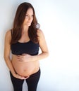 Thinking, pregnant and woman touching her stomach, future and health with wellness, nurture and growth. Female person Royalty Free Stock Photo