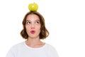 Thinking pretty caucasian woman holding apple on head Royalty Free Stock Photo