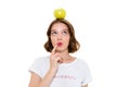 Thinking pretty caucasian woman holding apple on head Royalty Free Stock Photo