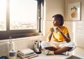 Thinking, serious and African woman drinking coffee while sitting on the kitchen counter alone at home. One content Royalty Free Stock Photo