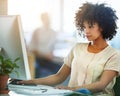 Thinking and serious black businesswoman working on a computer and paying attention in her office. Young female Royalty Free Stock Photo