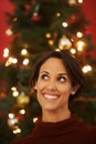 Thinking, smile and Christmas with woman, home and ideas for festive season and planning for decorations. Person