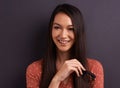 Thinking, smile and woman with idea in studio, laughing and remember memory isolated on a grey background with glasses