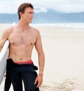 Thinking, space and shirtless man with surfboard on beach in wetsuit for travel, exercise or fitness. Nature, summer and