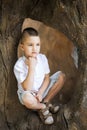 Thinking boy sitting in the tree Royalty Free Stock Photo