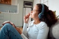 Thinking up her next idea. Young girl dreaming and writing in her journal. Young woman writing in her diary at home Royalty Free Stock Photo