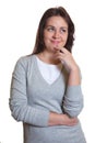 Thinking woman with dark hair has an idea Royalty Free Stock Photo