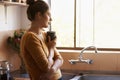 Thinking, woman and drinking coffee in home kitchen to relax, peace and planning future at breakfast in the morning Royalty Free Stock Photo