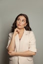 Thinking woman on gray background portrait Royalty Free Stock Photo