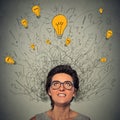 Thinking woman with question signs and light idea bulb above head Royalty Free Stock Photo