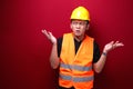 Thinking Young asian man worker is seriously think gesture on red background Royalty Free Stock Photo