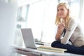 Thinking, young businesswoman with laptop and glasses at desk in office at work. Corporate, planning or idea and female Royalty Free Stock Photo