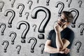 Thinking man with question marks Royalty Free Stock Photo