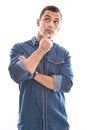 Thinking: young man in blue denim shirt isolated on white background Royalty Free Stock Photo