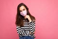 Thinking young pretty female person wearing mediacal face mask isolated over pink background wall