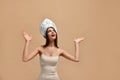 Thinking young woman in kokoshnik hat looking up on many questions over beige background. , Royalty Free Stock Photo