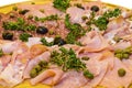 Thinly sliced ham and salami with greens. Royalty Free Stock Photo