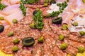 Thinly sliced ham and salami with greens. Royalty Free Stock Photo