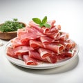 thinly sliced jamon with green leaves on a plate on the table