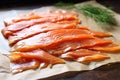 thinly sliced smoked salmon on parchment paper