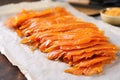 thinly sliced smoked salmon on parchment paper