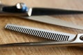 Thinning shears lie on wooden table Royalty Free Stock Photo