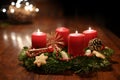 Third Advent - decorated Advent wreath from fir branches with red burning candles on a wooden table in the time before Christmas, Royalty Free Stock Photo