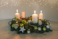 Third Advent, wreath with three burning white candles and green Christmas decoration on a table, home decor for the third Sunday, Royalty Free Stock Photo