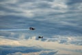 Third AirFestival at Chaika airfield. Two small red aircraft are flying towards. Thunderclouds at the background.