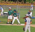 Third base coach. with boy on base.