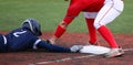 Third baseman tagging out runner who is head first sliding Royalty Free Stock Photo