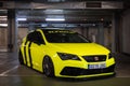 third generation Seat Leon yellow with tuned black stripes, it is parked in a garage