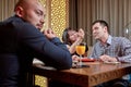 The third is superfluous. couple in love is having dinner in a restaurant with a lonely friend Royalty Free Stock Photo