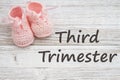 Third Trimester message with pink baby booties Royalty Free Stock Photo