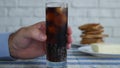 Thirsted Man Looking to a Chill Glass with Cola and Ice Cubes