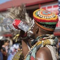 Thirsty African dancer drinking water