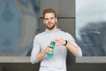 Thirsty concept. Young guy look thirsty. Thirsty man hold water bottle. A drop of water is life for a thirsty person Royalty Free Stock Photo
