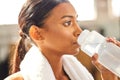 Thirsty, fitness or Indian woman drinking water at gym in training, workout or exercise to hydrate her body. Fatigue Royalty Free Stock Photo