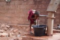 Thirsty Little African Girl Drinking Clean Fresh Water from the Village Borehole Royalty Free Stock Photo