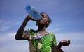 Thirsty Little African Girl Savoring Fresh Drinking Water From A Plastic Bottle